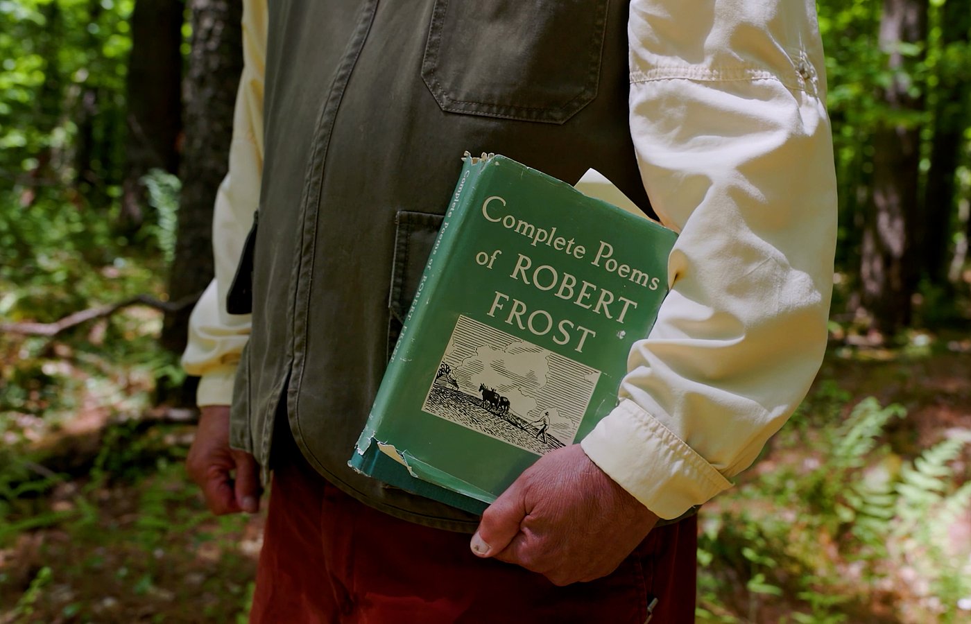 Jay Parini holding the Complete Poems of Robert Frost