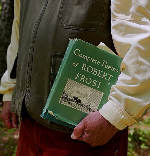 Jay Parini holding the Complete Poems of Robert Frost